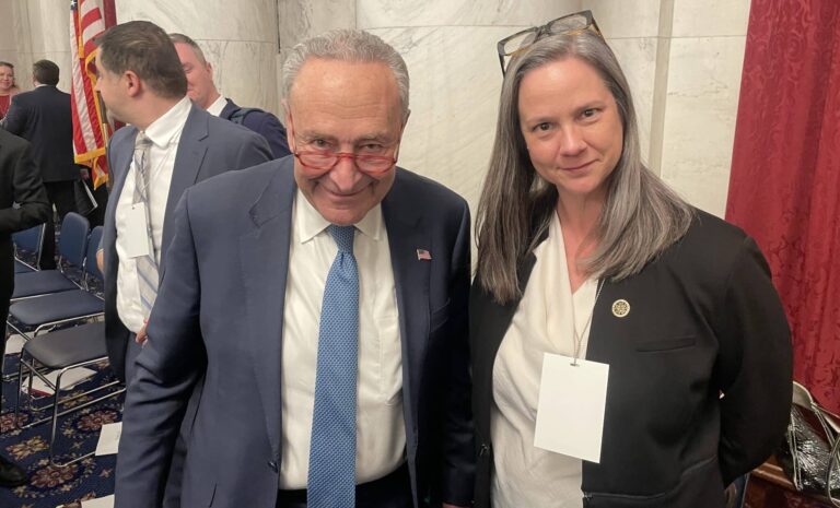 Vanessa Holtgrewe, Assistant Department Director, Motion Picture & Television Production, poses with Senate Majority Leader Chuck Schumer on November 29 in Washington, D.C. after her testimony at the bipartisan U.S. Senate AI Insight Forum on intellectual property and copyright.
